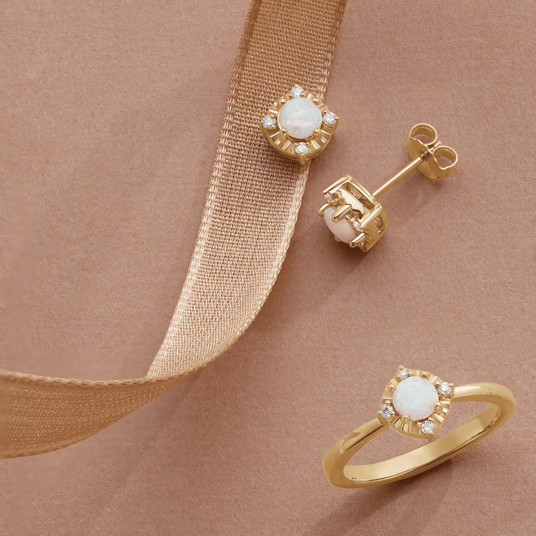 Gold opal and diamond ring and stud earrings set with ribbon accent