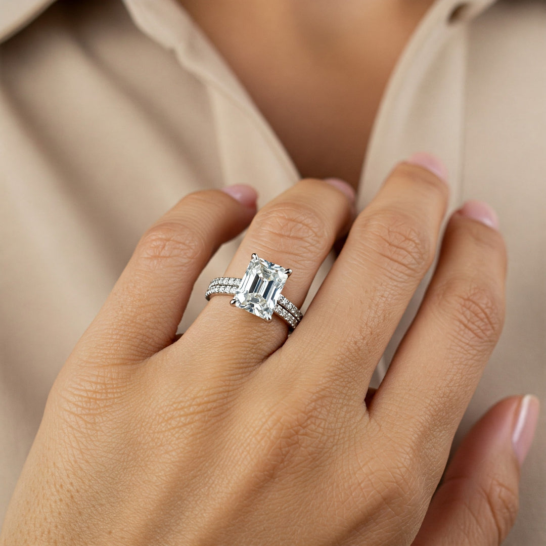 Elegant emerald cut diamond engagement ring with pave band, perfect for Charlotte brides.