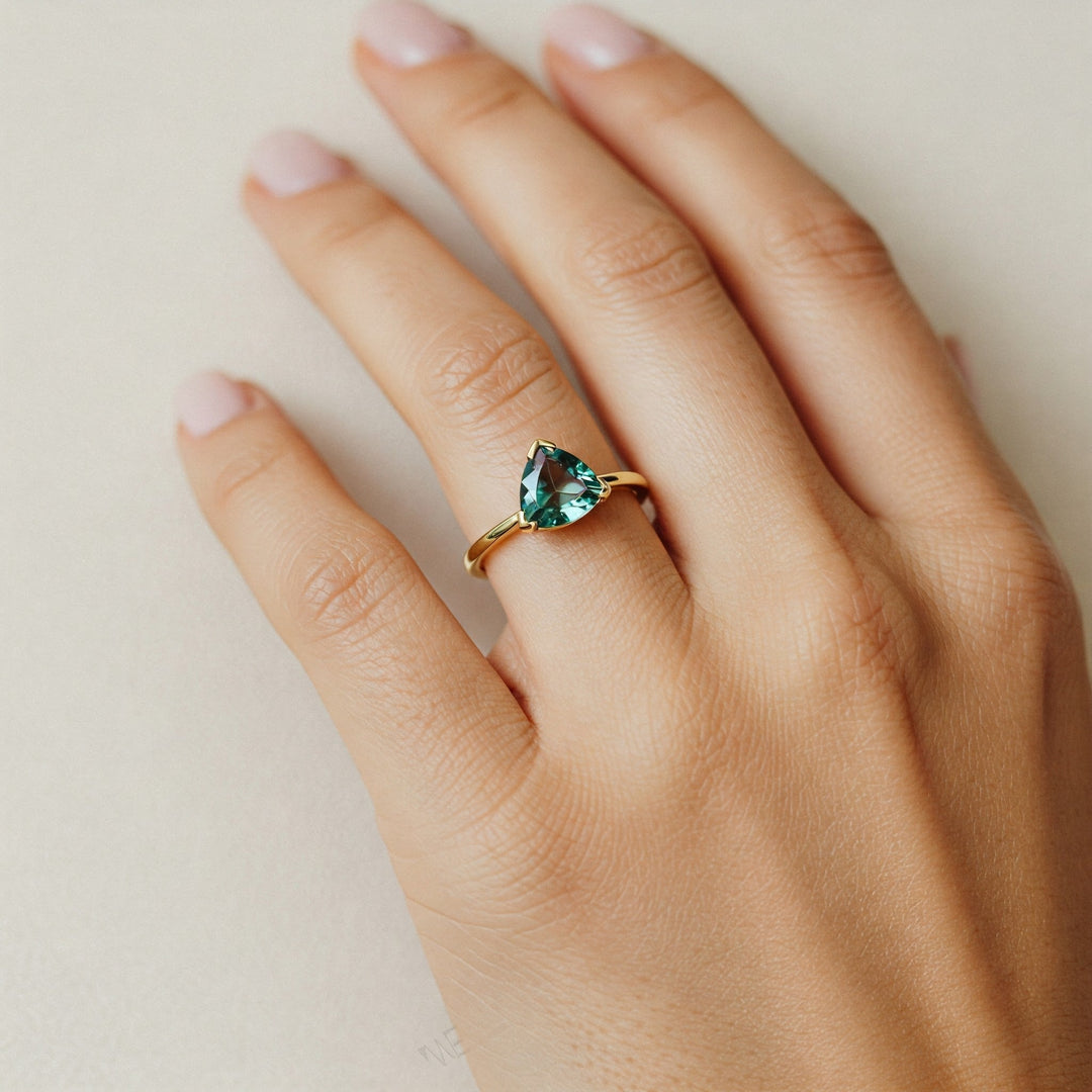 Gold ring with pear-cut green gemstone, elegant engagement or fashion jewelry