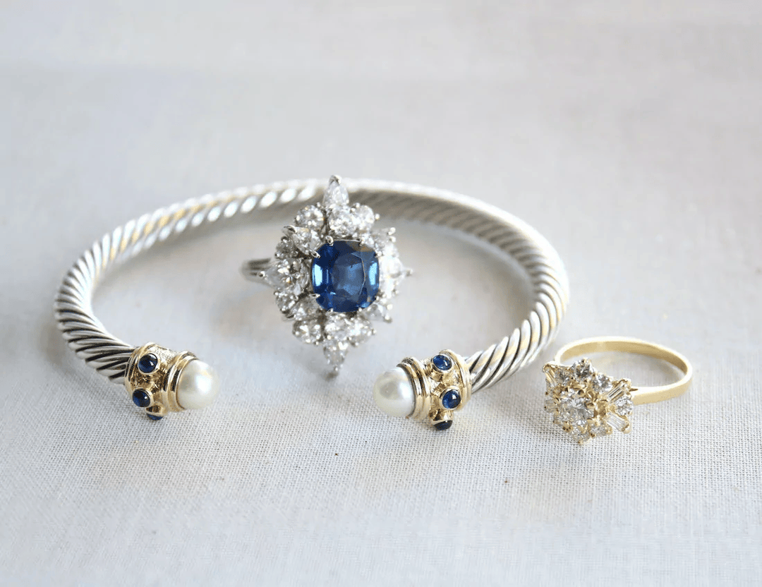 Elegant sapphire and diamond ring with pearl and sapphire bangle, perfect for engagement or estate jewelry collections.