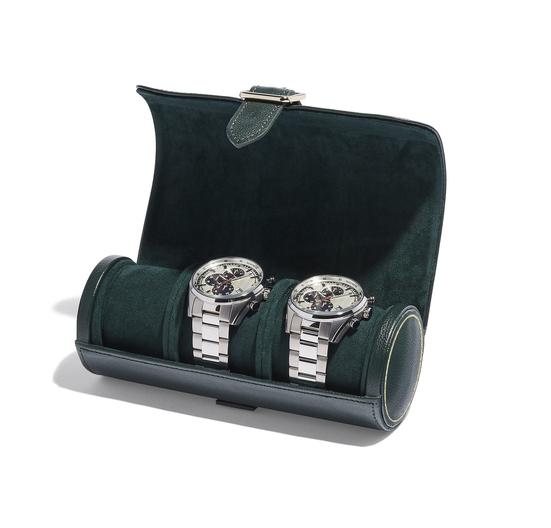 Two silver chronograph watches in a green velvet travel case, perfect for luxury watch storage and display.