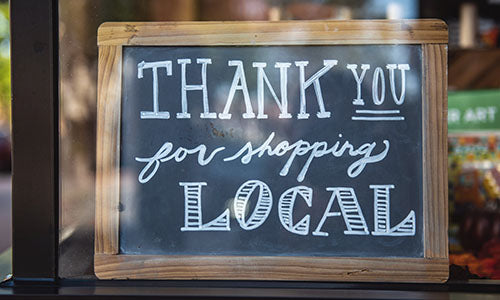 Thank you for shopping local sign in wooden frame at jewelry store