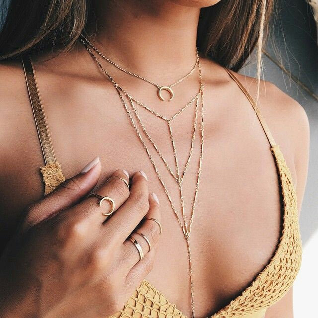 Layered gold body chain with crescent pendant and matching rings, perfect for boho or Indian jewelry styles.